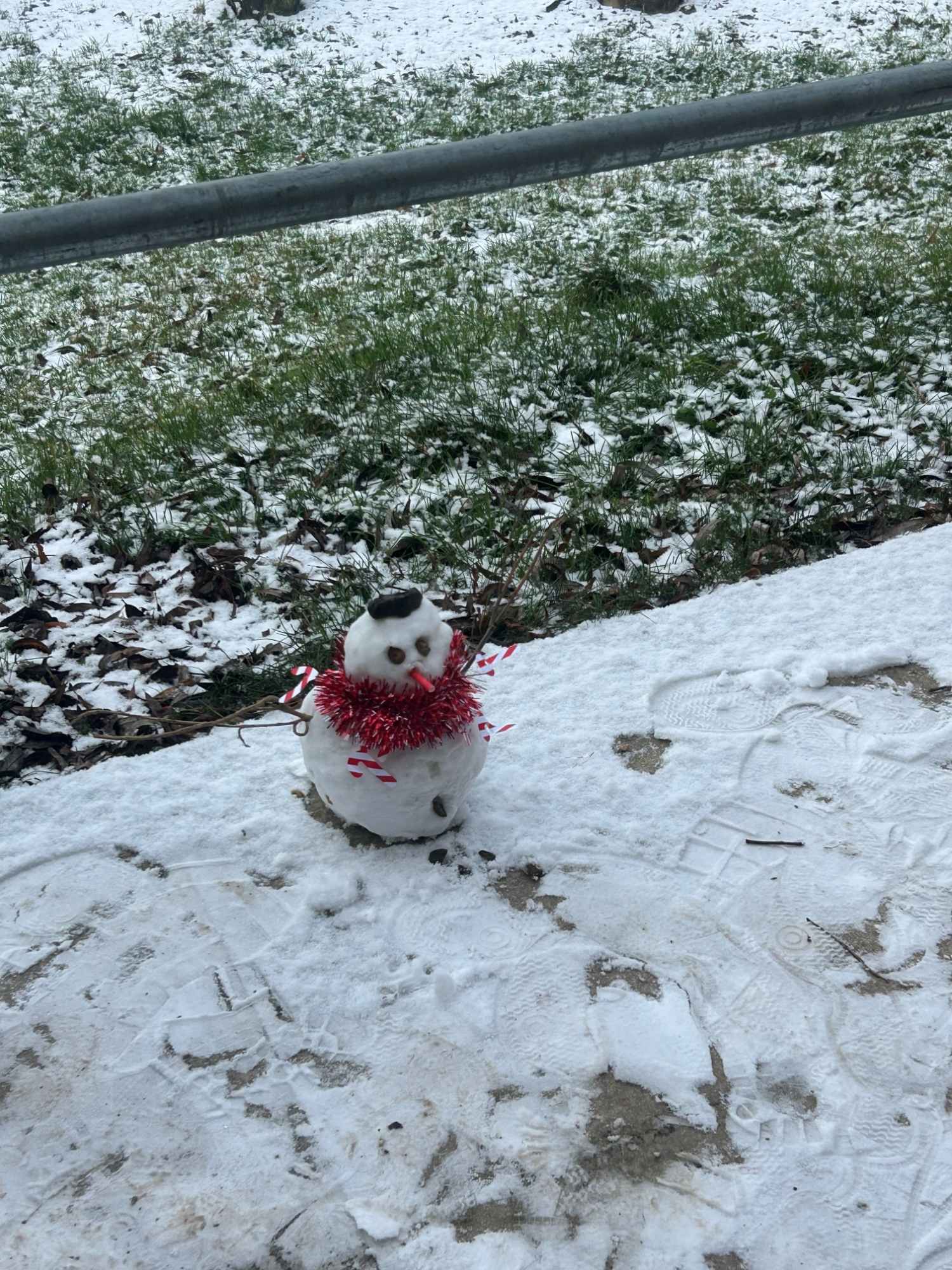 Small snowman with tinsel scarf